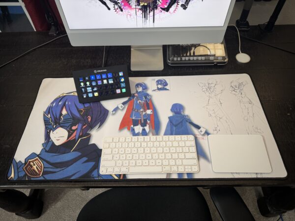 Lucina desk mat – Fire Emblem concept art mouse pad shown in real desk setup with iMac, Stream Deck, keyboard, and trackpad