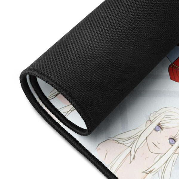 Close-up of Edelgard desk mat rolled edge – black anti-slip rubber backing with visible stitched edges and printed concept art