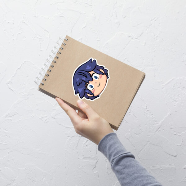 Fire Emblem sticker of Chrom (large, 5.5x5.5) displayed prominently on a brown spiral-bound notebook.