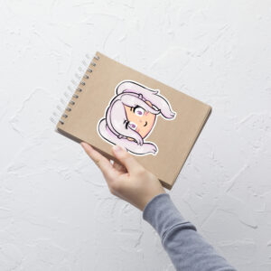 Fire Emblem sticker of Female Robin (large, 5.5x5.5) displayed prominently on a spiral notebook held upright.