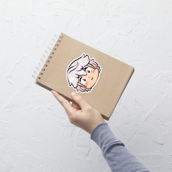 Fire Emblem sticker of Male Robin (large, 5.5x5.5) placed on a spiral notebook, highlighting size and detail.