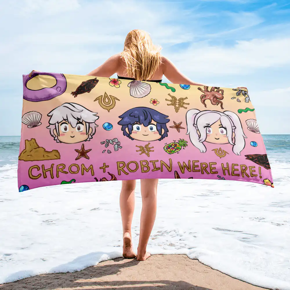 Summer Scramble (Sunset) - Beach Towel Person holding the Fire Emblem Towel horizontally at the beach, revealing the full Summer Scramble layout with chibi Chrom, Robin, and sunset-themed coastal graphics.