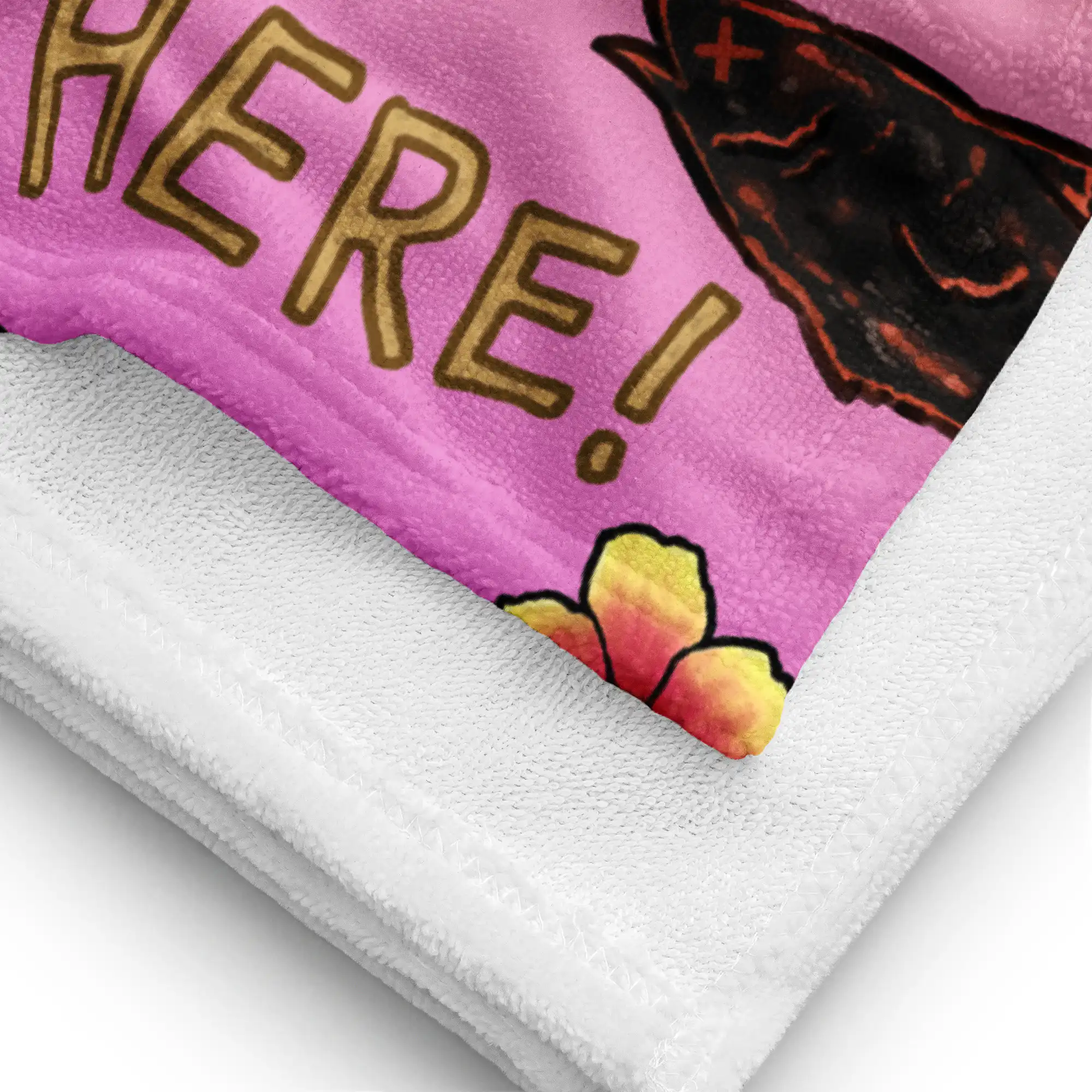 Summer Scramble (Sunset) - Beach Towel Close-up of the Fire Emblem Towel fabric and stitching, focusing on the “HERE!” text and beach details from the Summer Scramble design.