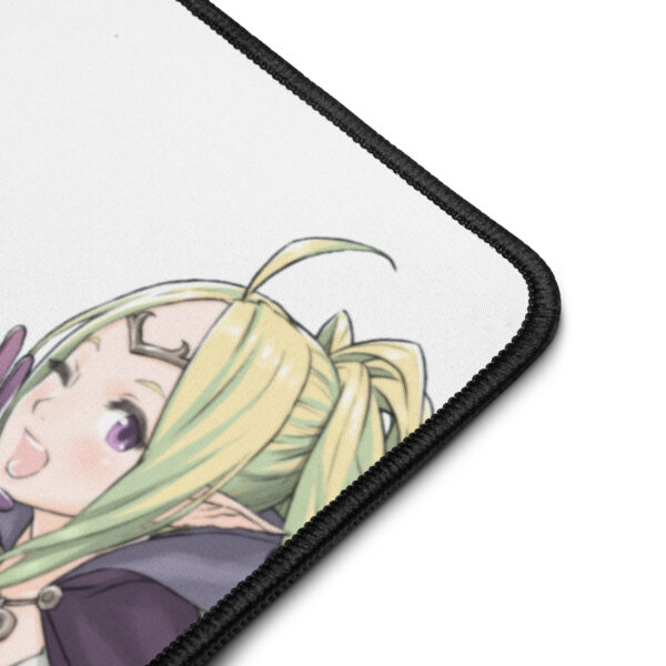 Zoomed-in shot of Nowi’s face printed on the corner of the Nowi desk mat, showing vivid color and fabric texture.