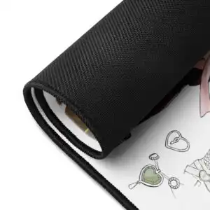 Close-up of a rolled Nowi desk mat showing detailed artwork and durable black edge stitching.