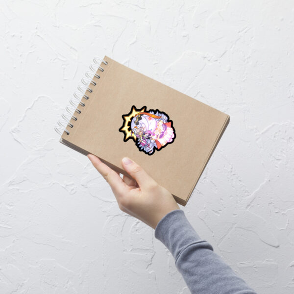 Medium Fire Emblem Sticker of Vali and Baldur displayed on a notebook for size reference.