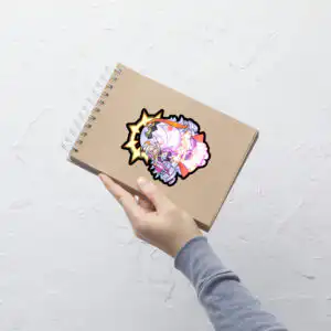 Large Fire Emblem Sticker of Vali and Baldur applied to a notebook, showing vibrant detail.