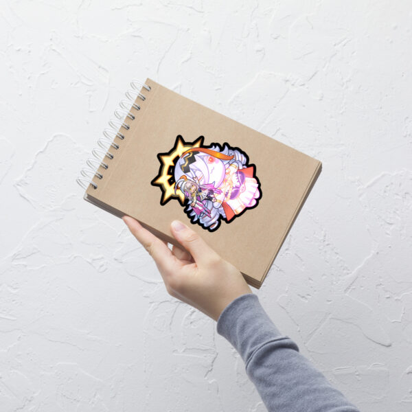 Large Fire Emblem Sticker of Vali and Baldur applied to a notebook, showing vibrant detail.
