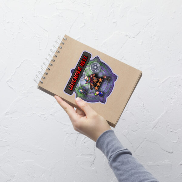 Notebook being tilted to show the vibrant, large Lavender Hell Fire Emblem Sticker design.