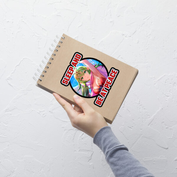 Large Fire Emblem Sticker of Tiki’s critical hit pose and quote placed on a spiral notebook for scale.
