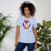 Fire Emblem Shirt – Best Brave Eikþyrnir design featured on a light blue unisex tee, modeled by a woman standing near plants.