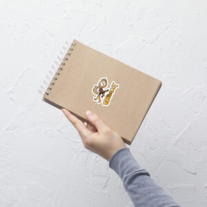 FEHology Sticker applied to a notebook with Joel chibi running and bold Lateology text