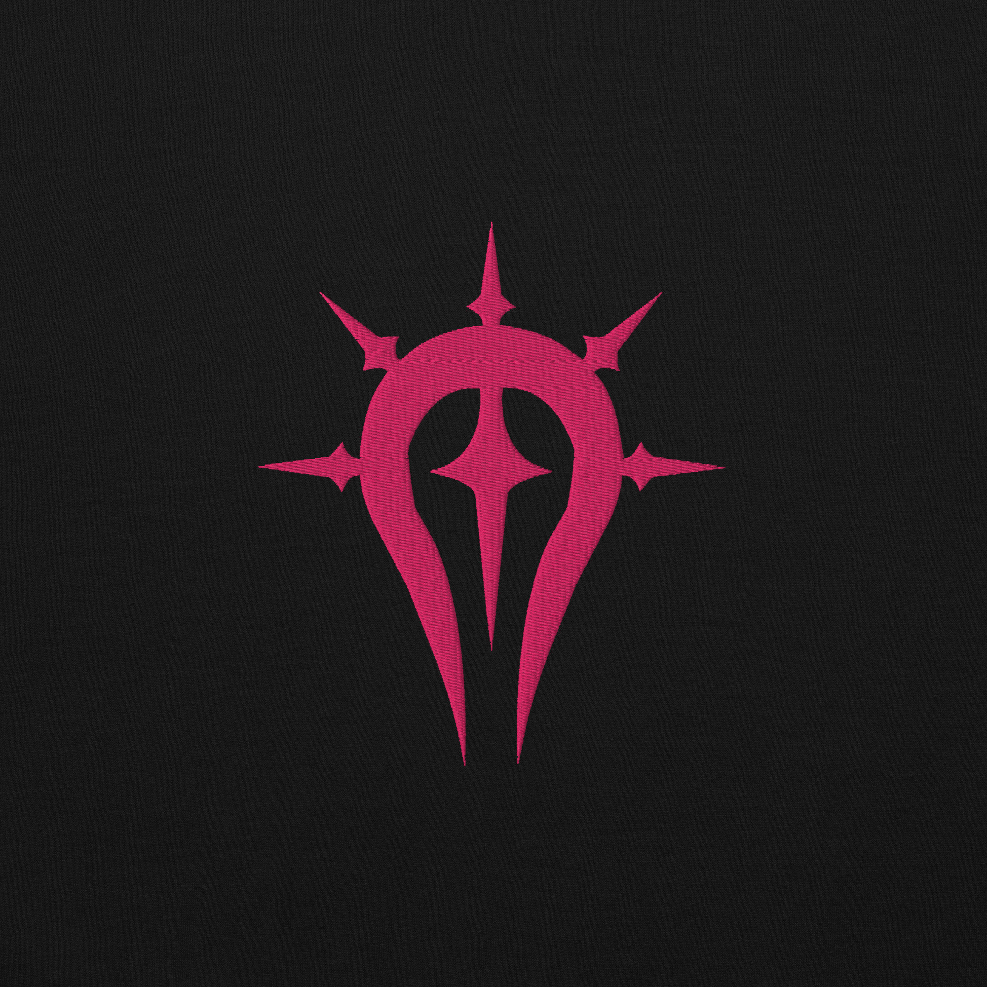 Duma Faithful - Unisex Embroidered Hoodie Fire Emblem Hoodie close-up of the pink embroidered Duma Faithful crest on black fabric.
