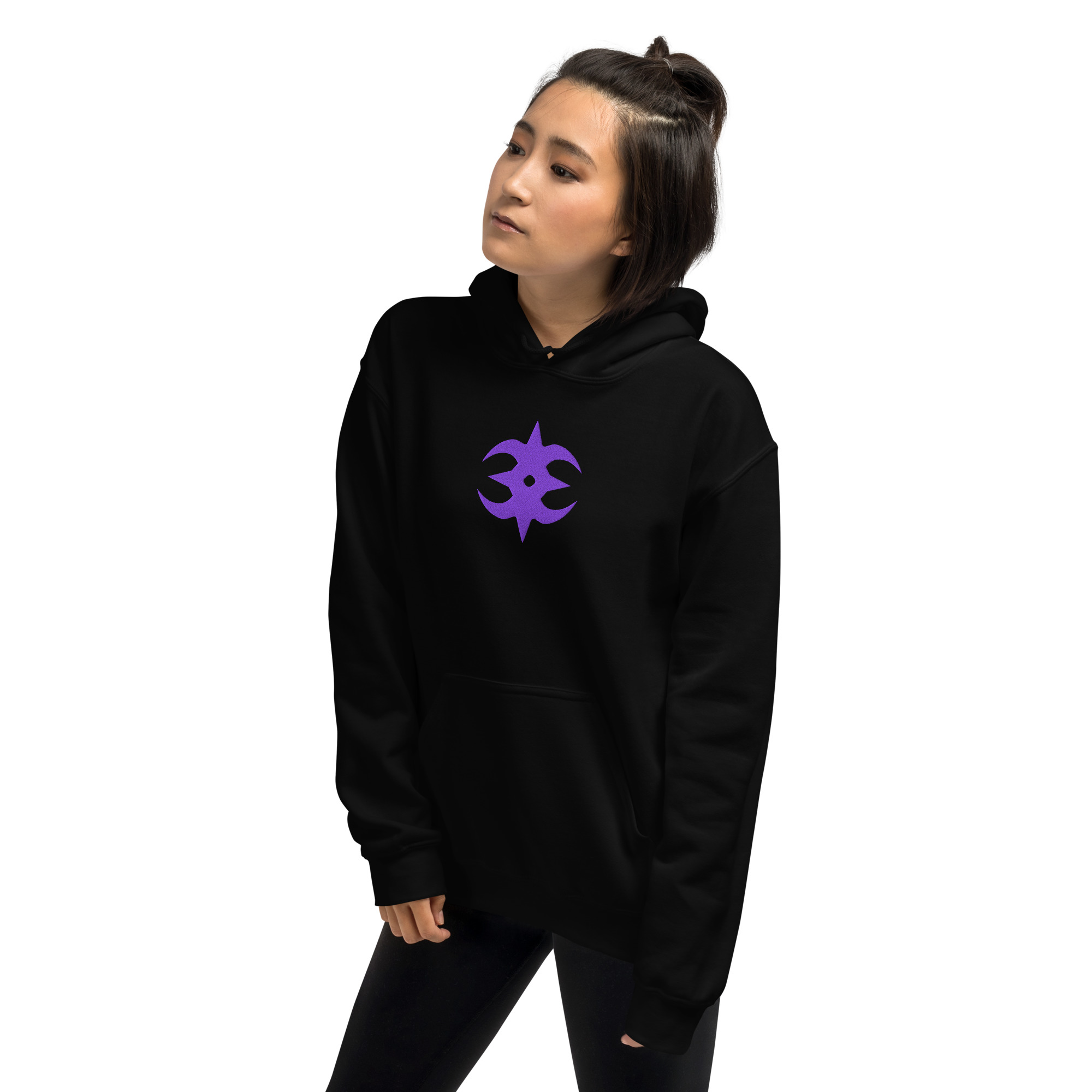 Nohr - Unisex Embroidered Hoodie Fire Emblem Hoodie in black showing the bold purple Nohr emblem, worn by a woman posing with hands in pockets.