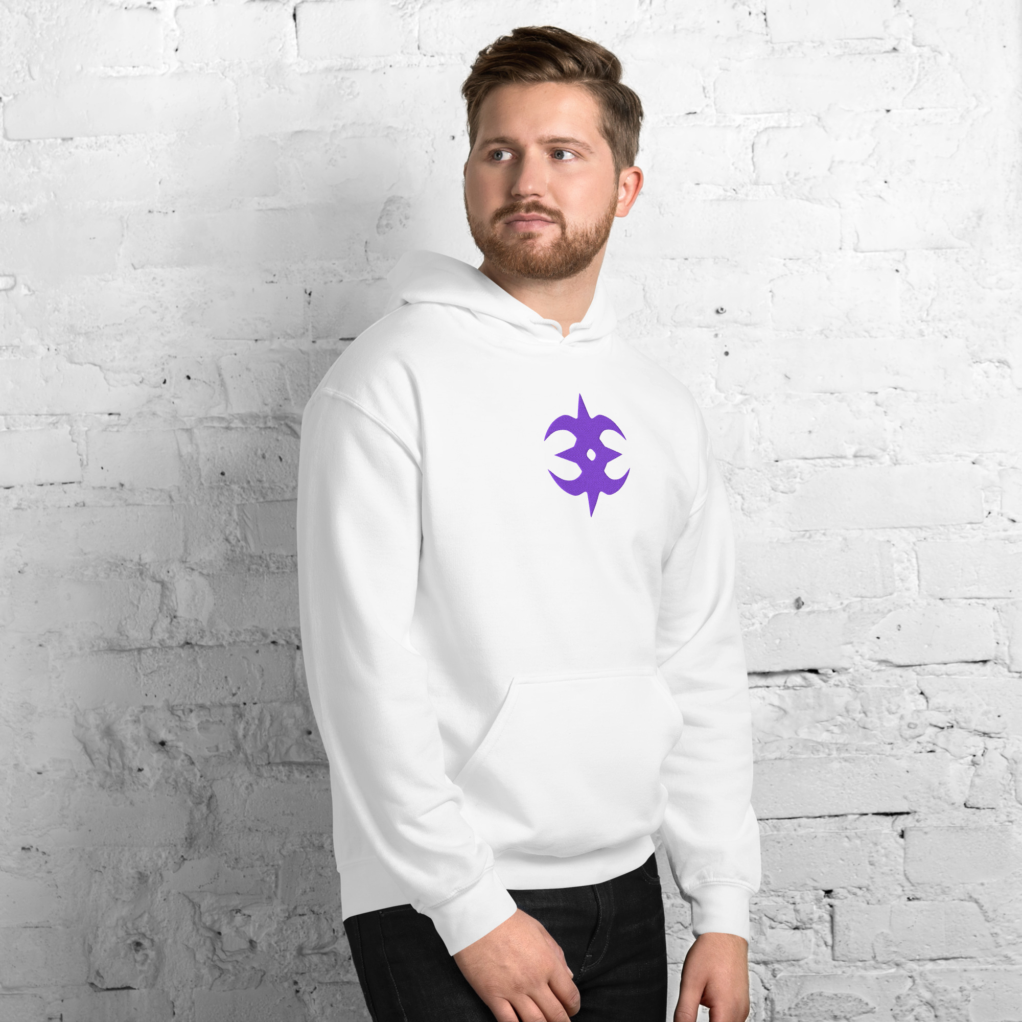 Nohr - Unisex Embroidered Hoodie Fire Emblem Hoodie in white with the Nohr crest design, modeled by a man against a gray brick wall.