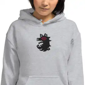 A model wearing the gray Fire Emblem Hoodie featuring the Shadows wolf emblem embroidered on the chest.