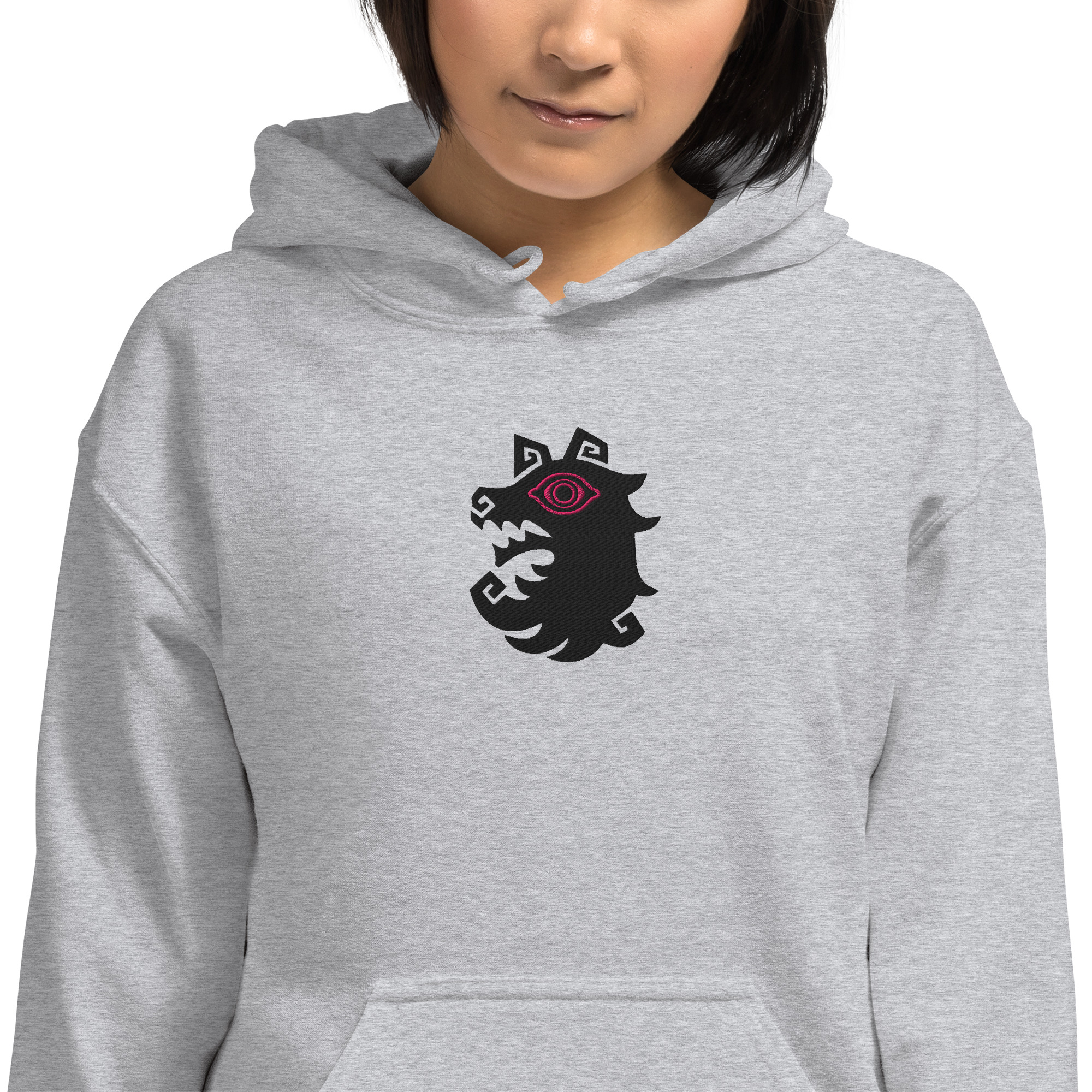 Shadows - Unisex Hoodie A model wearing the gray Fire Emblem Hoodie featuring the Shadows wolf emblem embroidered on the chest.