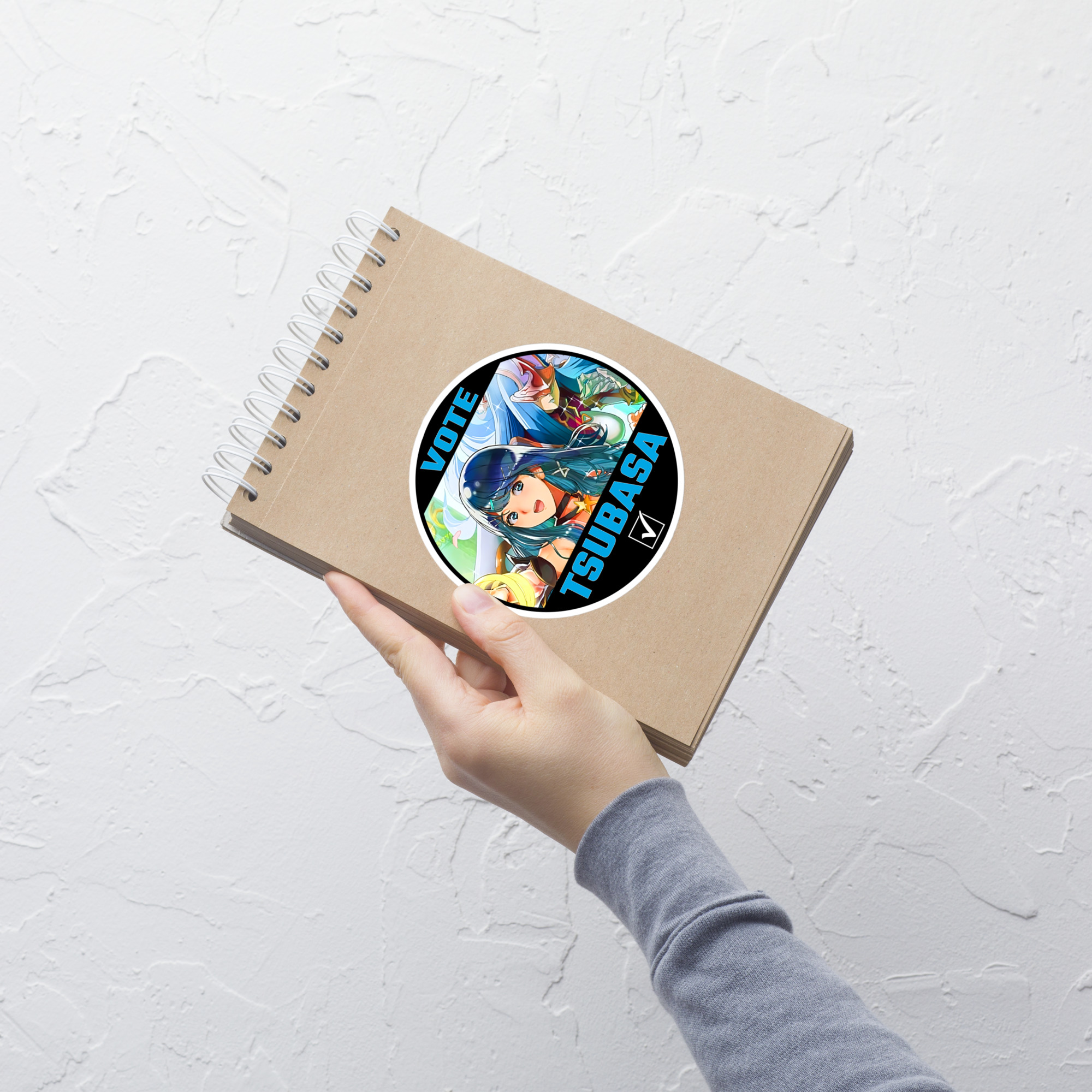 Vote for Tsubasa - Sticker 5x5 CYL10 Tsubasa Fire Emblem sticker displayed on a notebook in hand