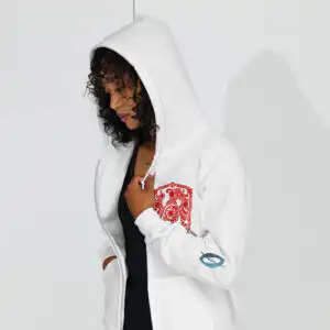 Fire Emblem Hoodie -Cipher inspired zip hoodie in white, lifestyle view on model with additional arm art
