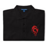 Folded black Fire Emblem polo with red Loptous Tome symbol embroidered on the chest