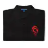 Folded black Fire Emblem polo with red Loptous Tome symbol embroidered on the chest