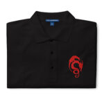 Folded black Fire Emblem polo with red Loptous Tome symbol embroidered on the chest