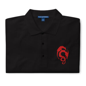 Folded black Fire Emblem polo with red Loptous Tome symbol embroidered on the chest
