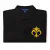 Folded black Fire Emblem polo with gold Emblem of Mila embroidered on the chest
