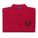 Folded red Fire Emblem polo with black Grimleal symbol embroidered on the chest