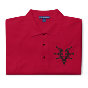 Folded red Fire Emblem polo with black Grimleal symbol embroidered on the chest