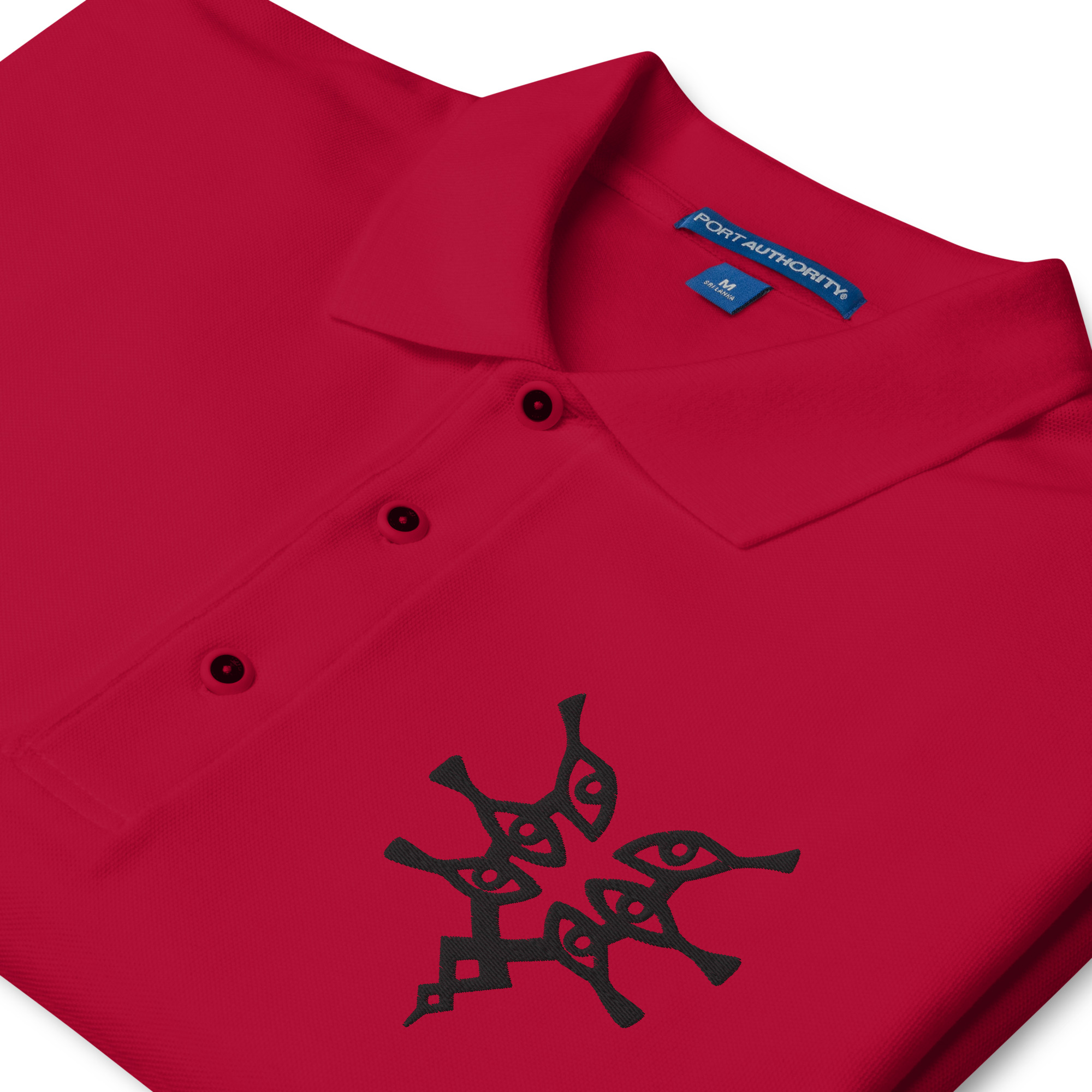 Grimleal - Embroidered Polo Close-up of red polo collar with black Grimleal embroidery