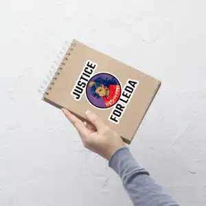 FEH Summon Simulator Fire Emblem sticker with Justice for Leda graphic displayed on a notebook cover