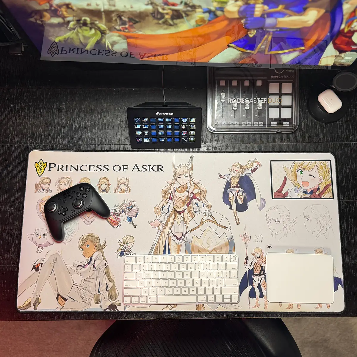 16x32 Fire Emblem Desk Mat with Sharena concept art displayed on a desk with a keyboard, gaming controller and stream deck.